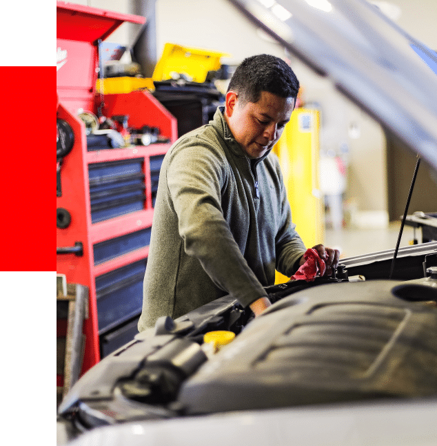 vehicle diagnostic services at Barrett Automotive image of male technician checking over vehicle engine in shop bay