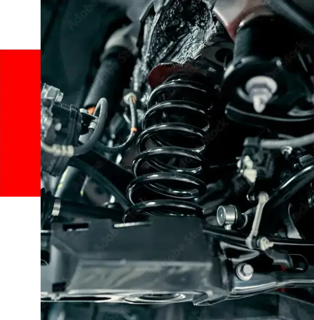 Close-up of a car's suspension system featuring a spring, shock absorber, and various mechanical components essential for steering and suspension repair.